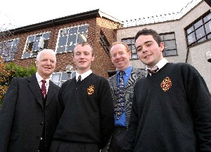 Brother O'Mahoney, Superiour of the Brothers' Community in Newry congratulates the two pupils on their unique achievement. Also included is their Irish Teacher Mr Sean McClory, Head of Irish.